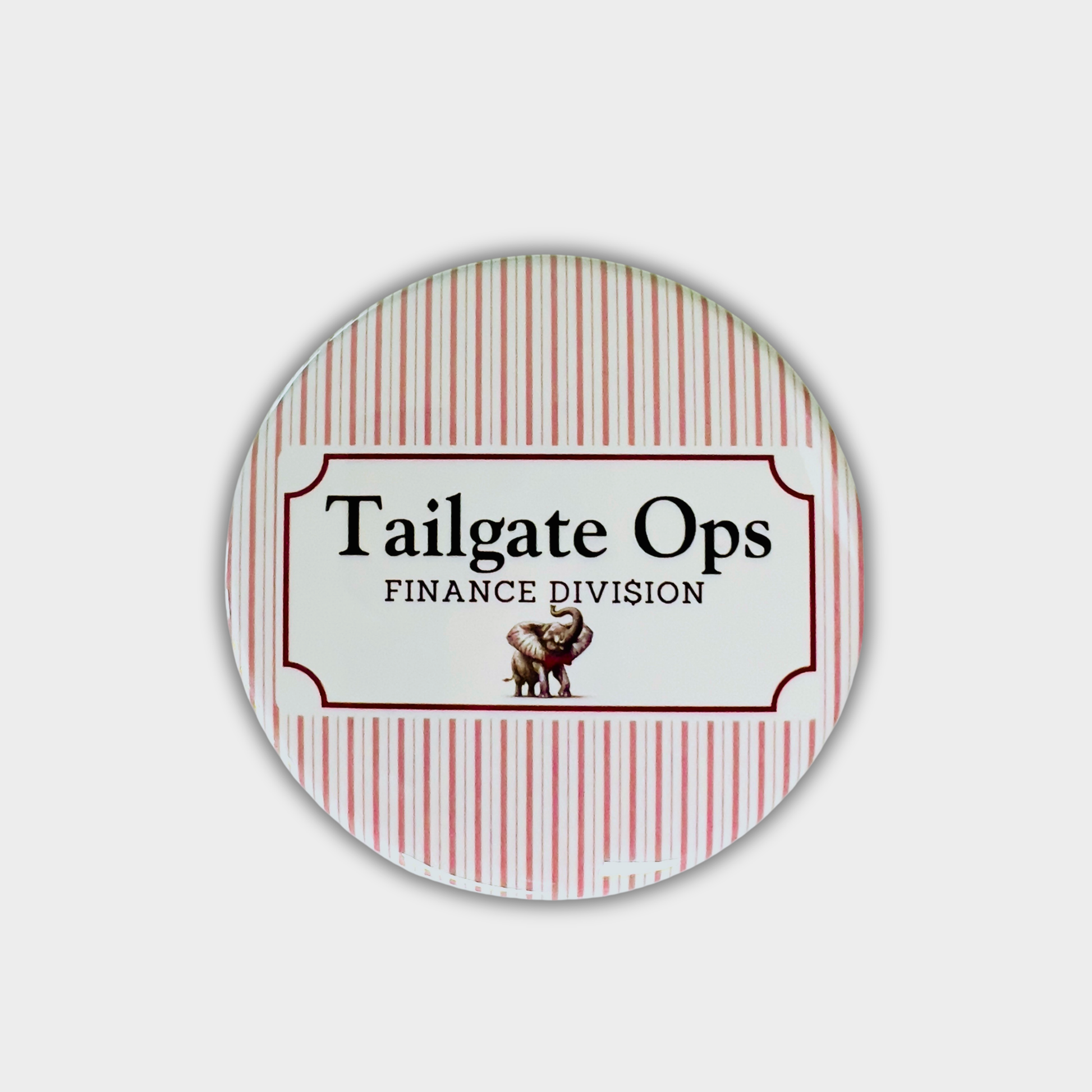 Round button with 'Tailgate Ops Finance Division' text and an elephant graphic on a red and white striped background.