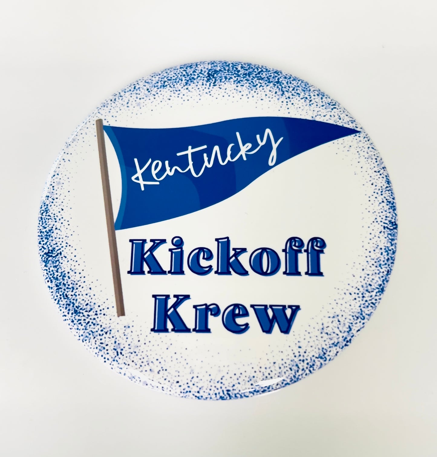 Circular button with a blue flag and text 'Kentucky Kickoff Krew' on a white background