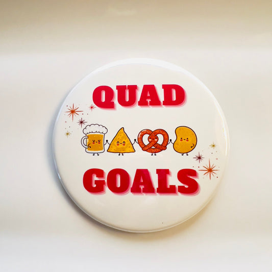 Button badge with 'Quad Goals' text and cartoon snack friends holding hands on a white background