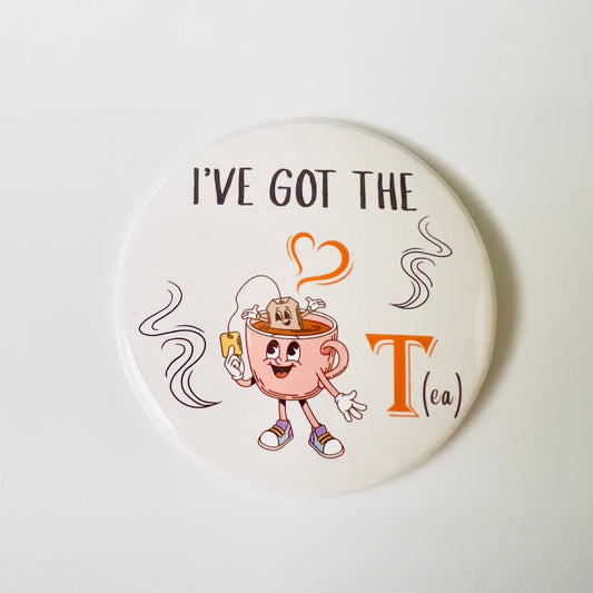 Round button with cartoon teacup character and text 'I've Got the Tea' on a white background