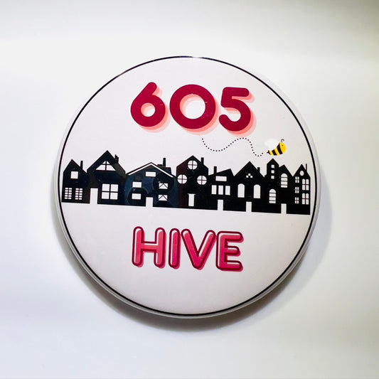 Round button with '605 Hive' text and town illustration on a light background