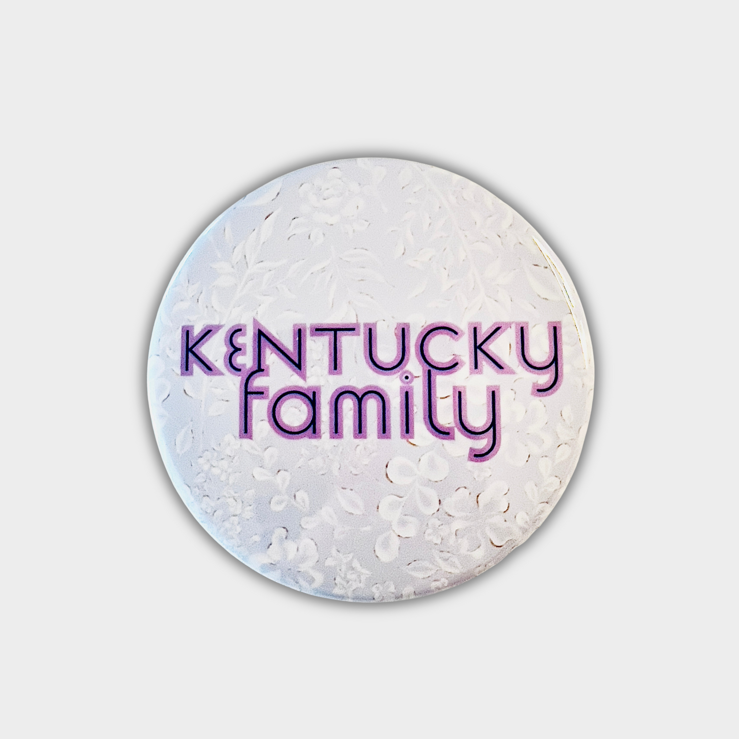 Round button with 'Kentucky family' text on a light gray background