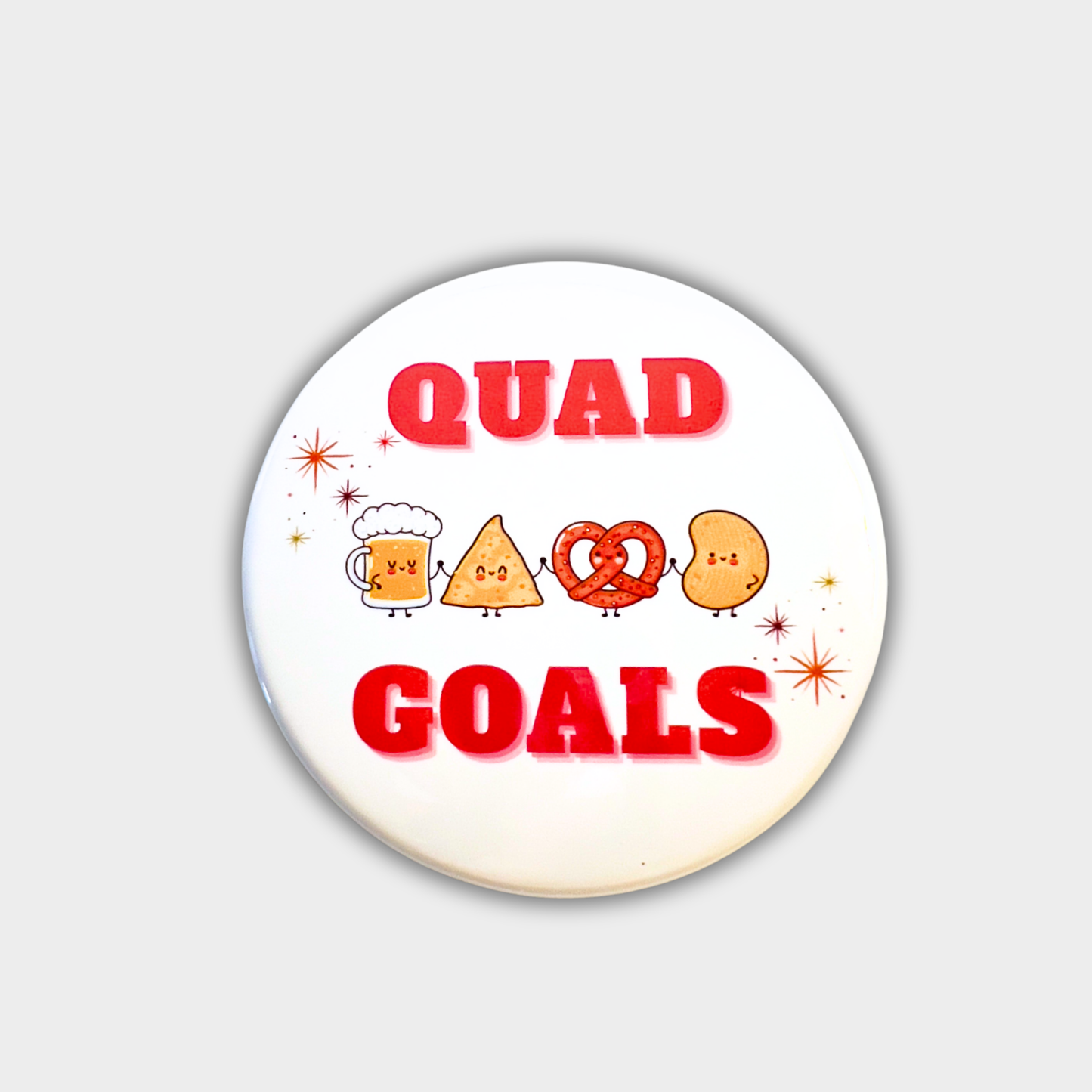 Round button with 'QUAD GOALS' text and cartoon characters on a white background