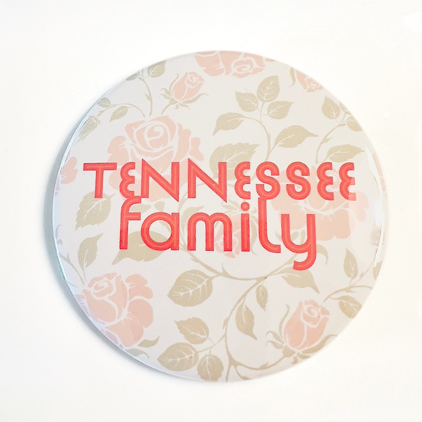 Round button with 'TENNESSEE family' text and floral design on a white background